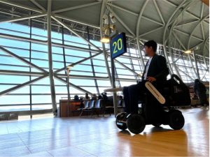 A man is using the WHILL autonomous mobility device at the Kansai International Airport