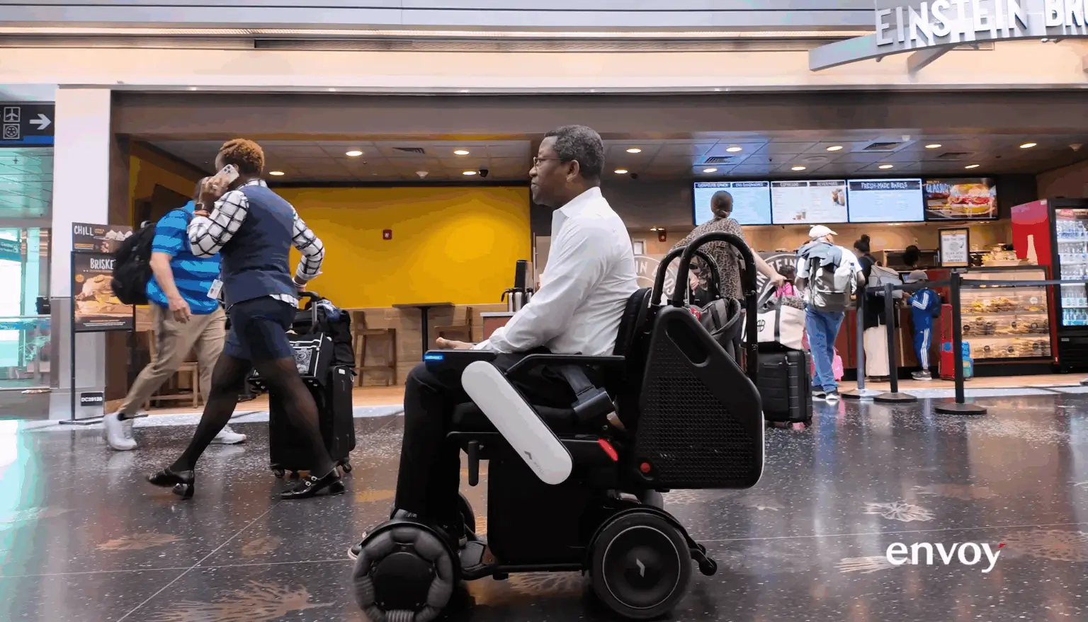 Man in the WHILL autonomous service device in the airport.