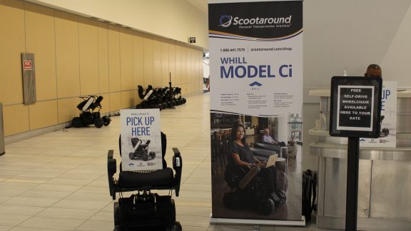 power chairs against a wall with podium and signage