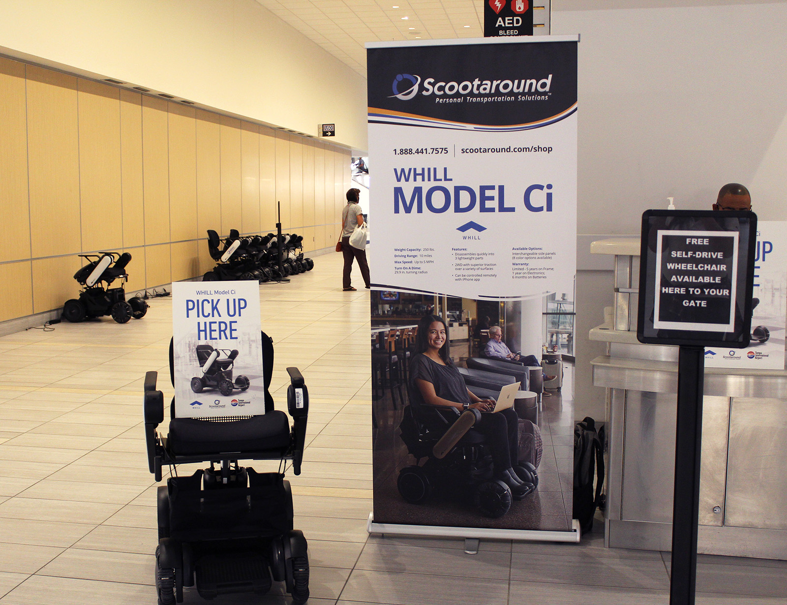 WHILL Power Chair and Signage at Tampa Airport