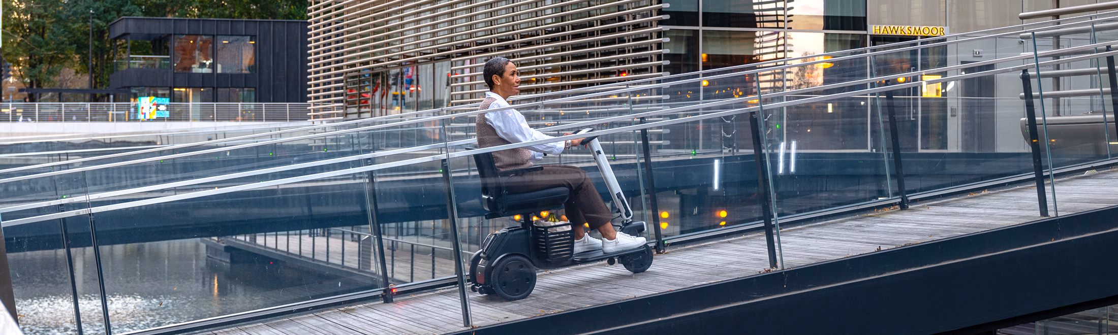 A person using WHILL 3 wheel mobility scooter